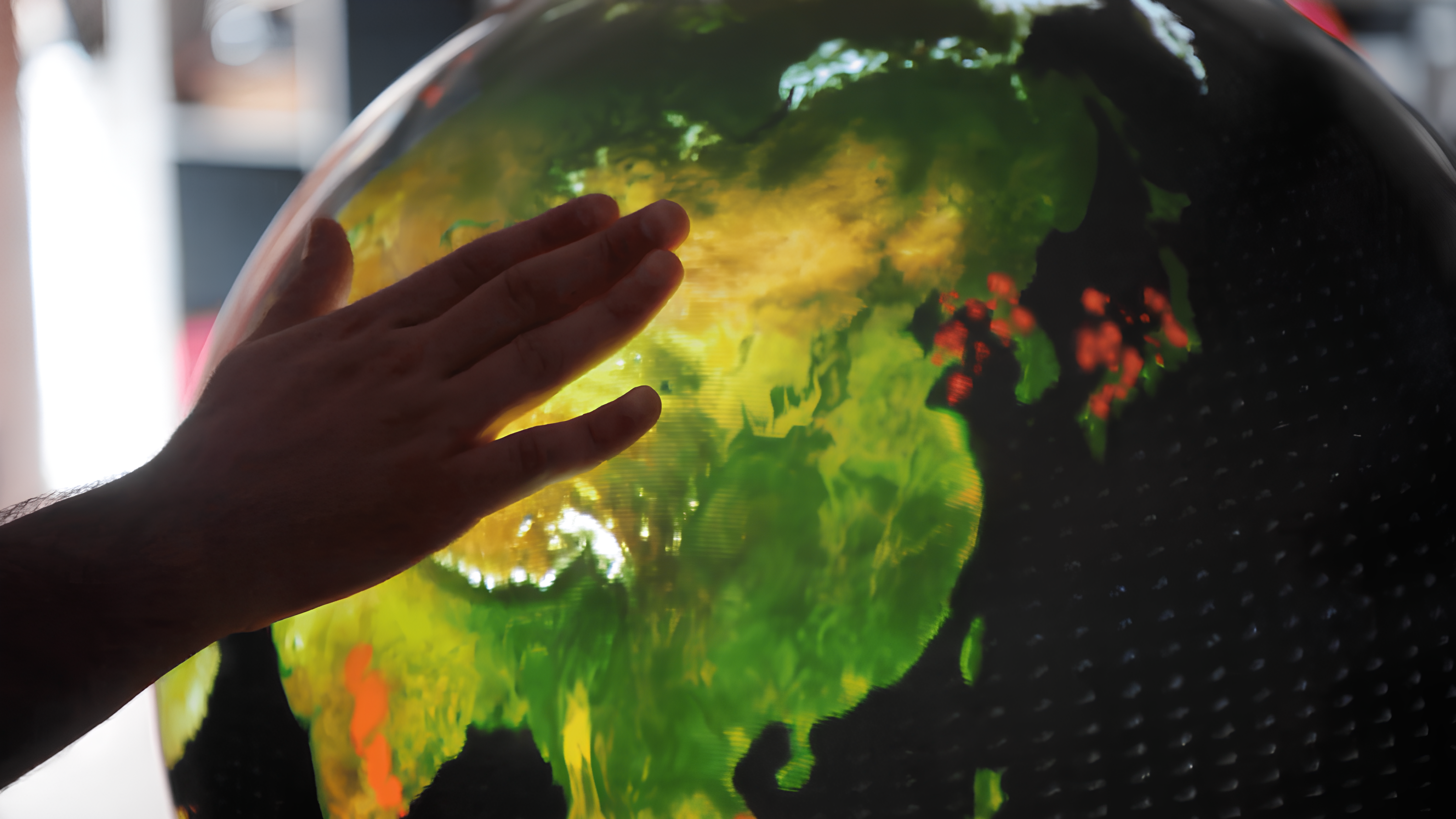 The first interactive geosphere for navigating global YouTube content, enabling users to touch pins representing videos for instant viewing. Environment and sustainability feature image.